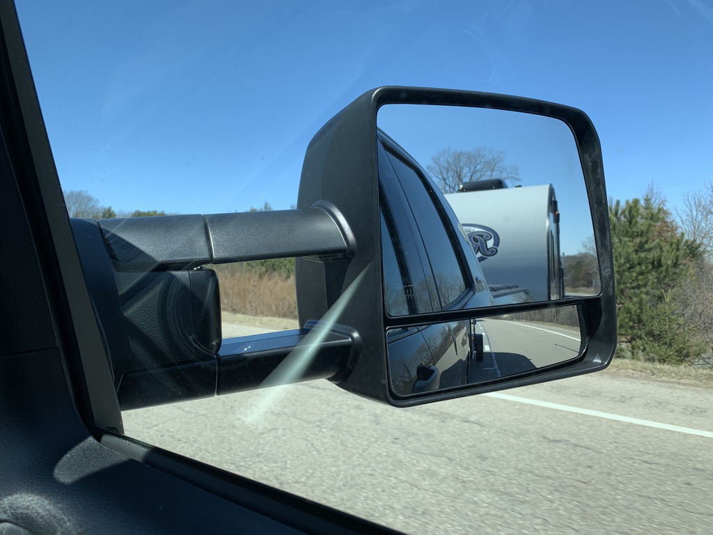 A side view mirror of a car

Description automatically generated